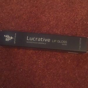 Younique Lucrative lipgloss in the color livid